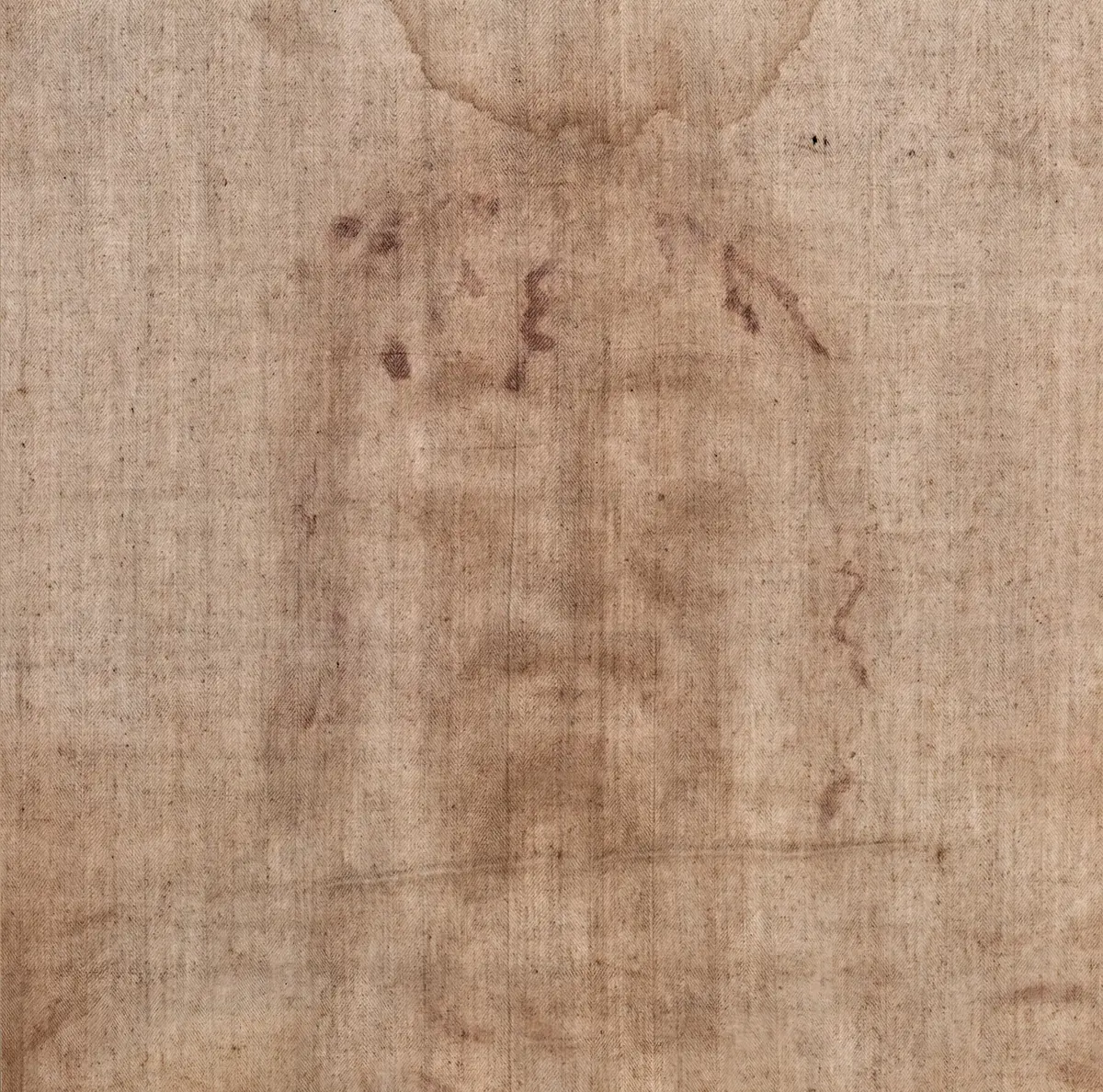 The face on the cloth in colour, as the eye sees it: faint sepia marks on pale linen.